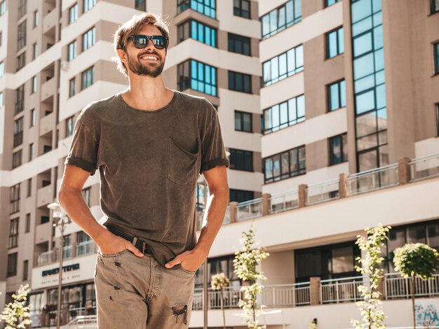 Portrait of handsome smiling stylish hipster lambersexual model