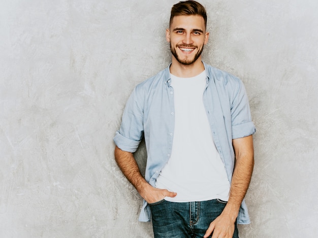 Portrait of handsome smiling young man model wearing casual shirt clothes. Fashion stylish man posing