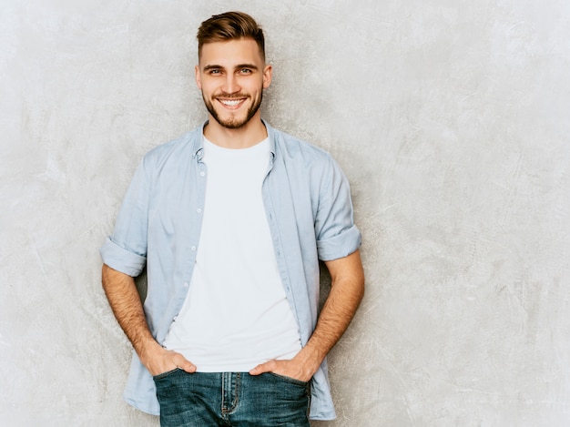 Portrait of handsome smiling young man model wearing casual shirt clothes. Fashion stylish man posing