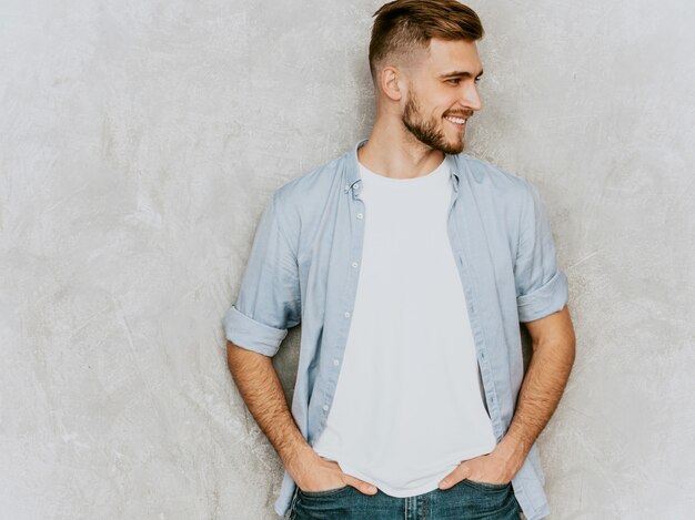 Portrait of handsome smiling young man model wearing casual shirt clothes. fashion stylish man posing