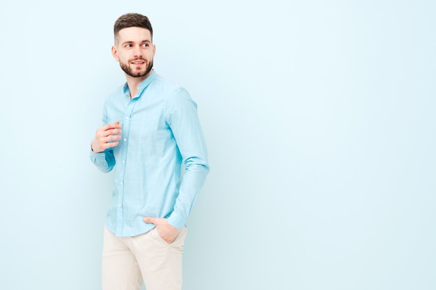 Portrait of handsome smiling young man wearing casual shirt and trousers