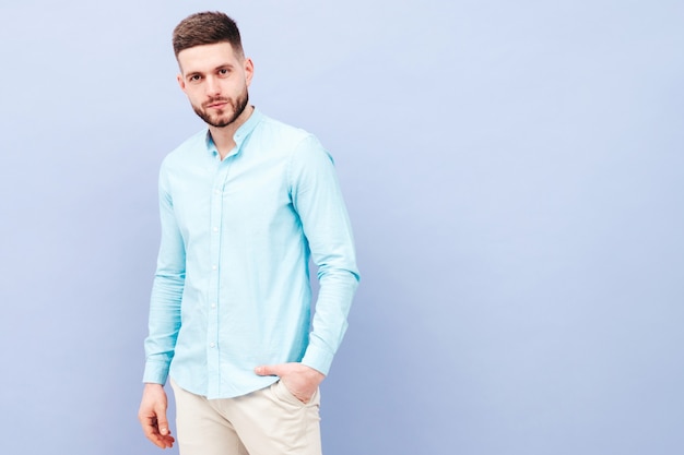 Portrait of handsome smiling young man wearing casual shirt and trousers