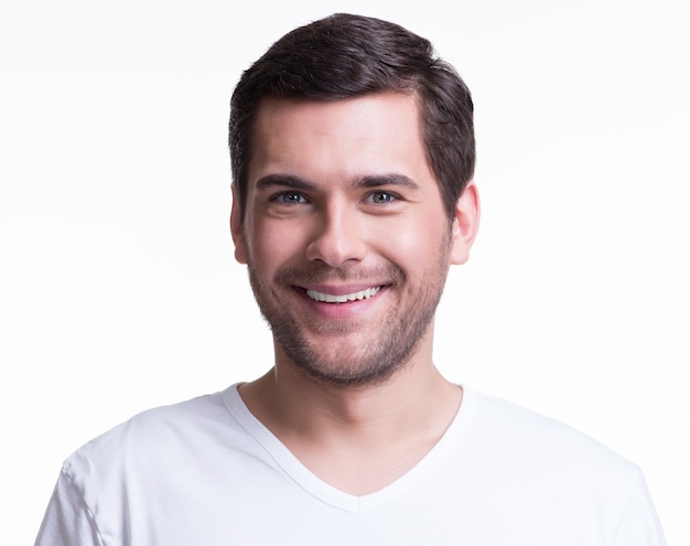 Portrait of handsome smiling young man in a white t-shirt - isolated on white.