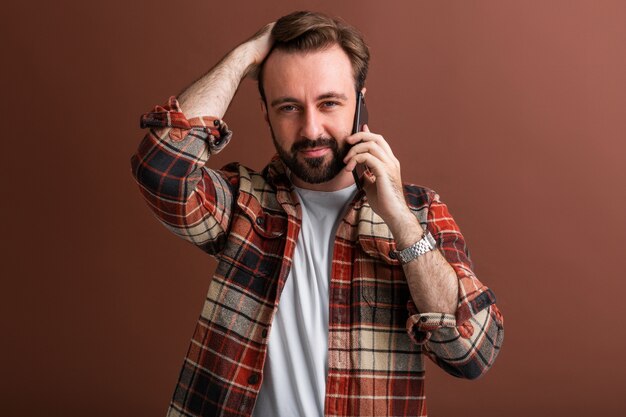 Portrait of handsome stylish bearded man on brown