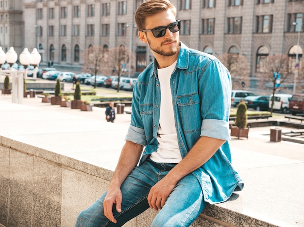 Portrait of handsome stylish hipster lumbersexual businessman model. Man dressed in jeans jacket clothes. 