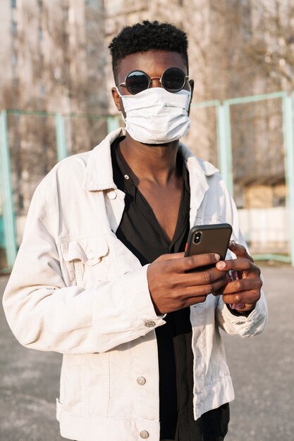 Portrait of handsome teenager posing with medical mask