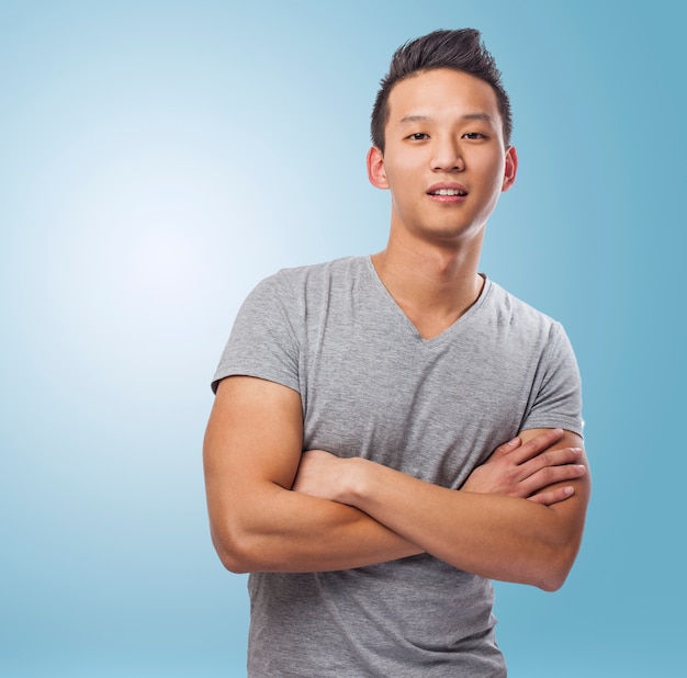 portrait of handsome young asian man standing over blue backgrou