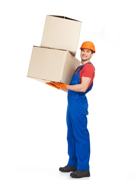 Portrait of handsome young delivery man with paper boxes isolated on white