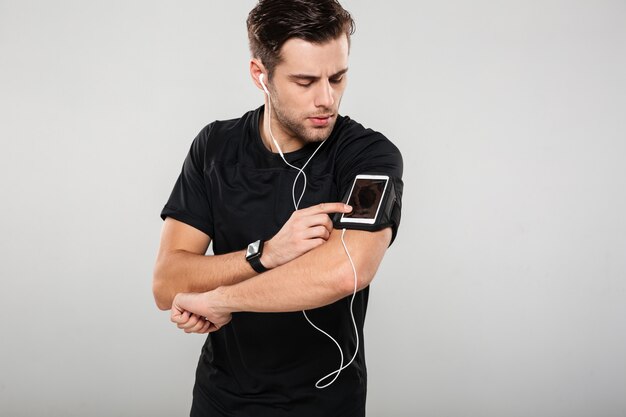 Portrait of a handsome young man athlete in earphones