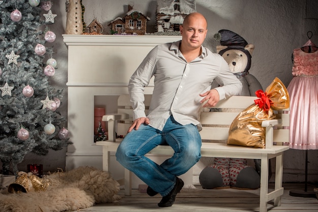 Portrait of  handsome young man in the Christmas interior