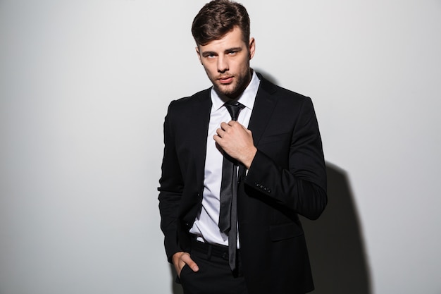 Portrait of a handsome young man in suit posing