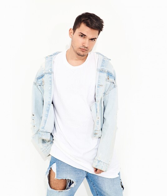 Portrait of handsome young model man dressed in jeans clothes posing. Isolated