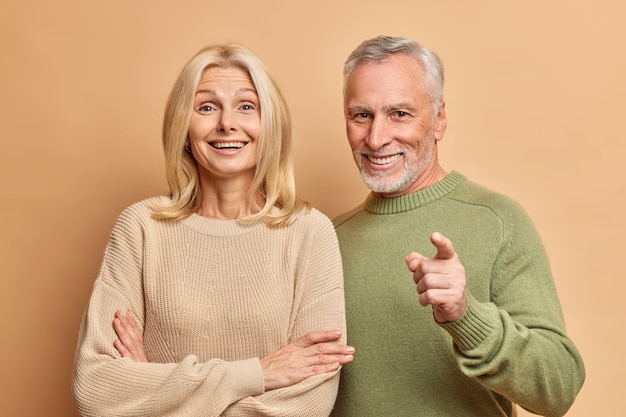 Portrait of happy aged woman and man stand closely to each other