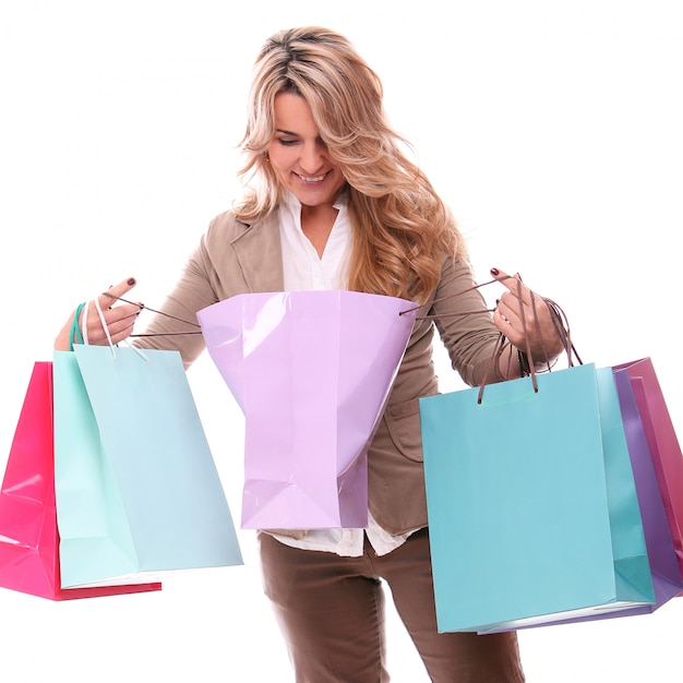 Portrait of happy aged woman with shopping bags