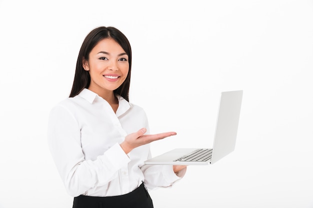 Portrait of a happy asian businesswoman holding laptop