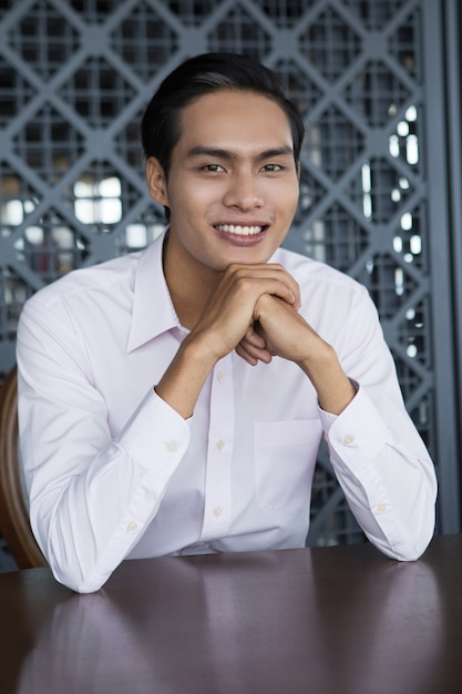 Portrait of Happy Asian Man Sitting in Restaurant