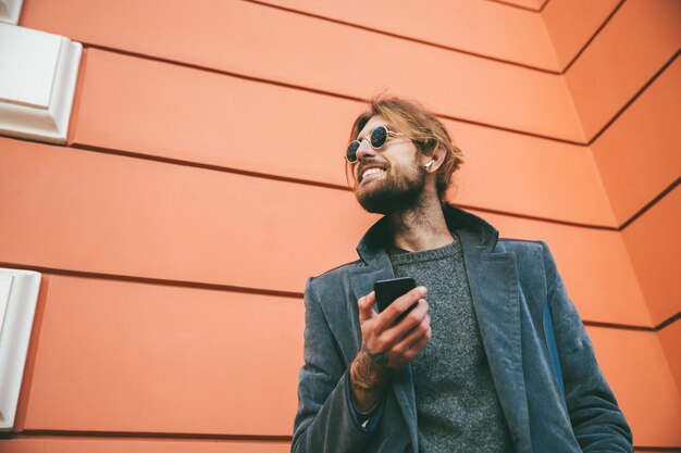 Portrait of a happy bearded man dressed in coat