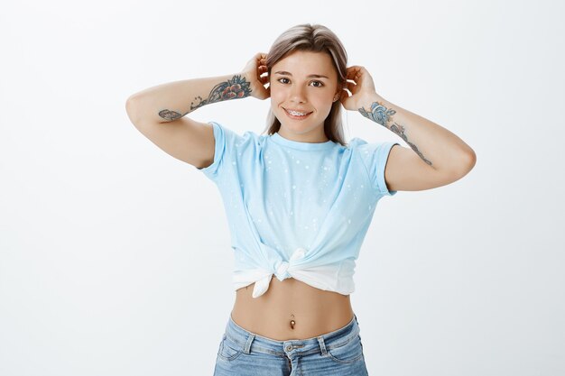 Portrait of happy blonde girl posing in the studio