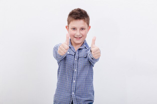 Portrait of happy boy showing thumbs up gesture