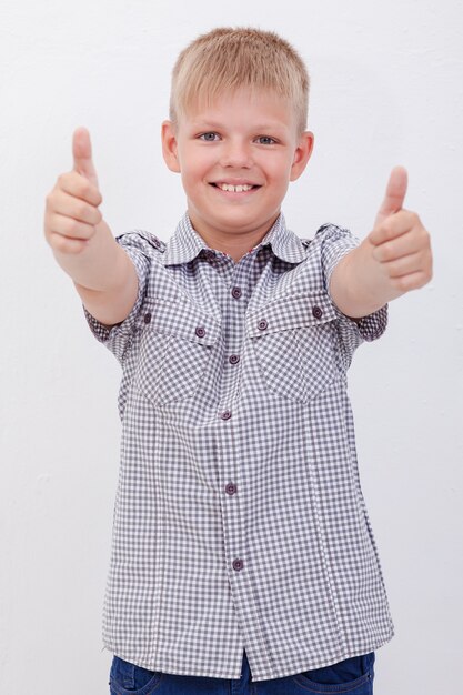 Portrait of happy boy showing thumbs up gesture