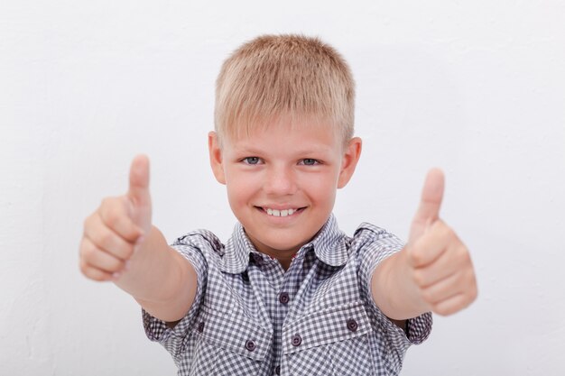 Portrait of happy boy showing thumbs up gesture