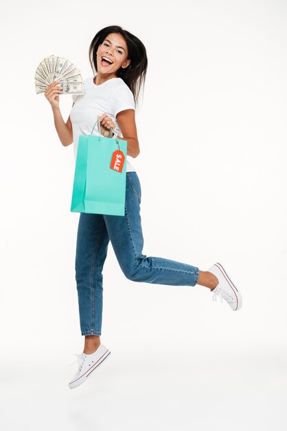 Portrait of a happy brunette woman jumping