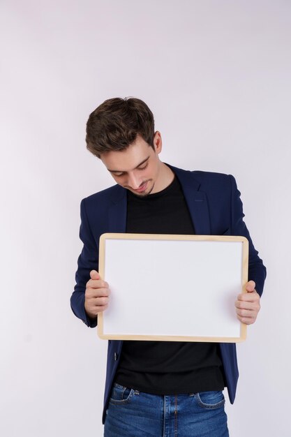 Portrait of happy businessman showing blank signboard on isolated white background