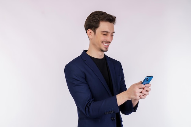 Portrait of a happy businessman using smartphone over white background
