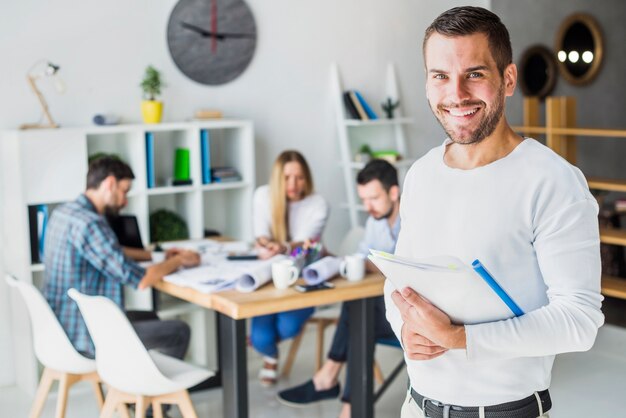 Portrait of a happy businessman with folder