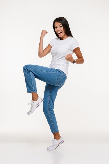 Portrait of happy casual woman celebrating success