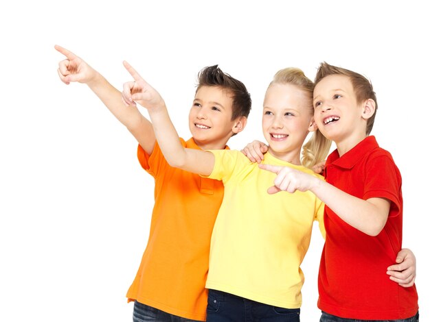 Portrait of the happy children point by finger on something away -  isolated on white