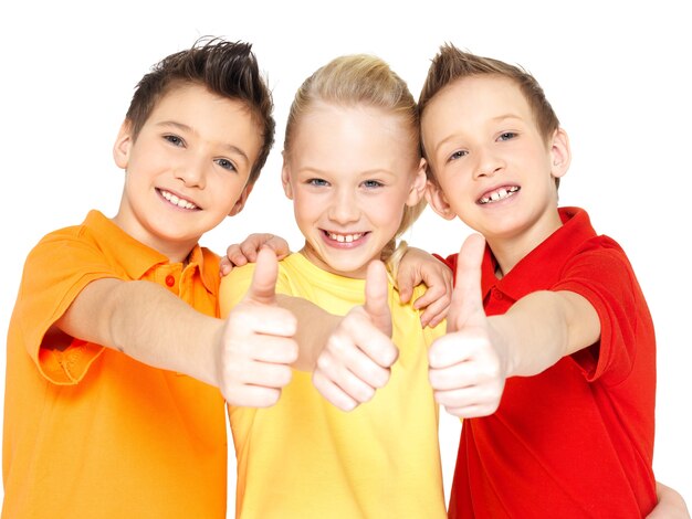 Portrait of the happy children with thumbs up gesture  isolated on white.