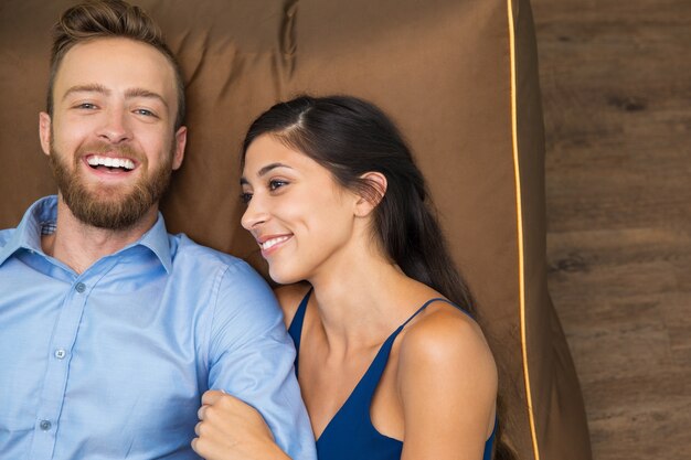 Portrait of happy couple spending time on sofa