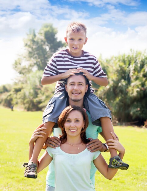 Portrait of happy couple with teenage son