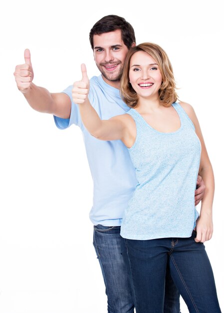 Portrait of happy couple with thumbs up sign isolated