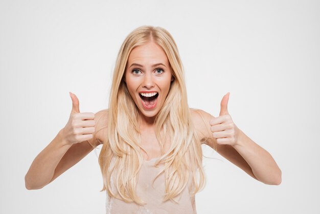 Portrait of a happy excited woman showing thumbs up