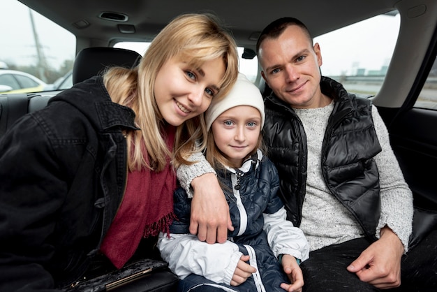 Free photo portrait of happy family in car