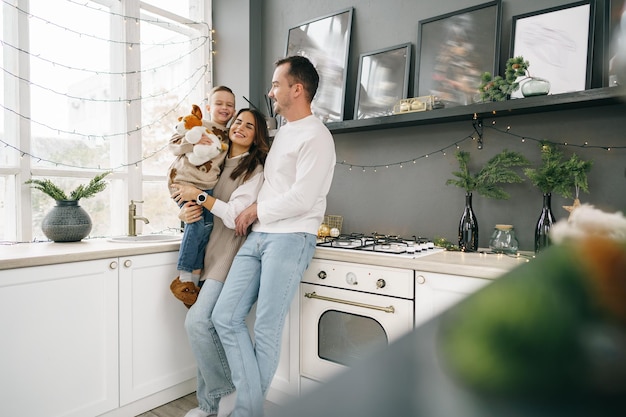 Free photo a portrait of happy family in the kitchen decorated for christmas