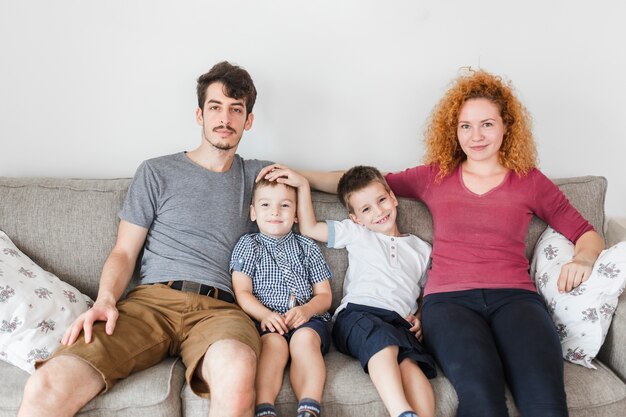 Portrait of a happy family sitting on sofa at home