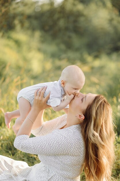 Portrait of Happy family at sunset spending time and playing in nature