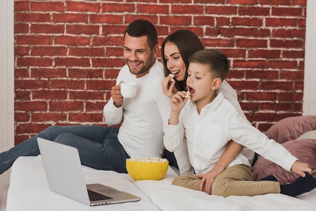 Free photo portrait of happy family watching a movie