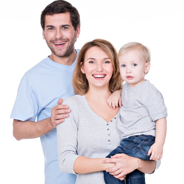 Portrait of the happy family with little baby standing
