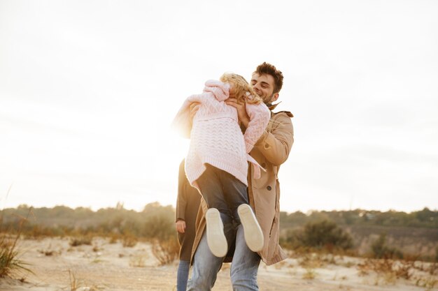 Portrait of a happy family with a little daughter