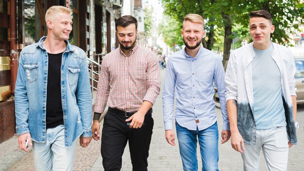 Portrait of happy friends walking together on street