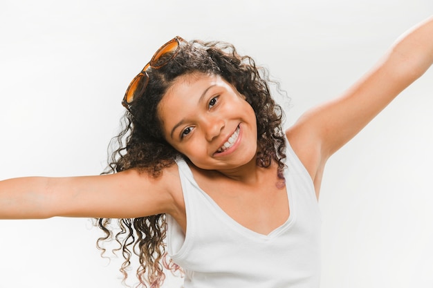 Free photo portrait of a happy girl with stretched arms