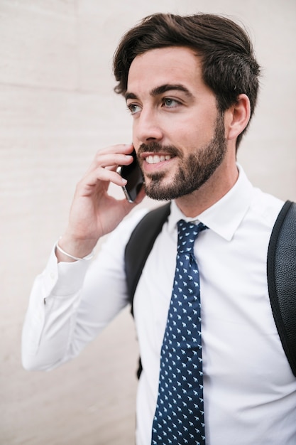 Portrait of a happy handsome man talking on cellphone