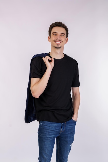 Portrait of happy handsome young man in suit posing on isolated background