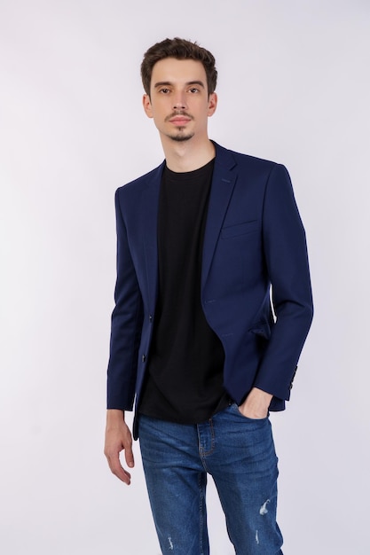 Portrait of happy handsome young man in suit posing on isolated background