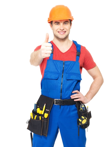 Portrait of happy handyman with tools showing thumbs up sign isolated on white