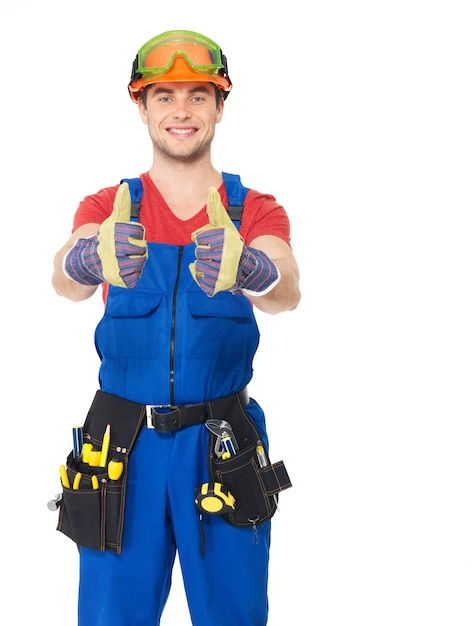 Free photo portrait of happy handyman with tools showing thumbs up sign isolated on white